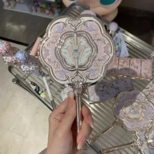 Miroir de poche vintage en métal rose avec manche sculpté