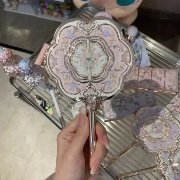 miroir-de-poche-vintage-1 Miroir de poche vintage en métal rose avec manche sculpté